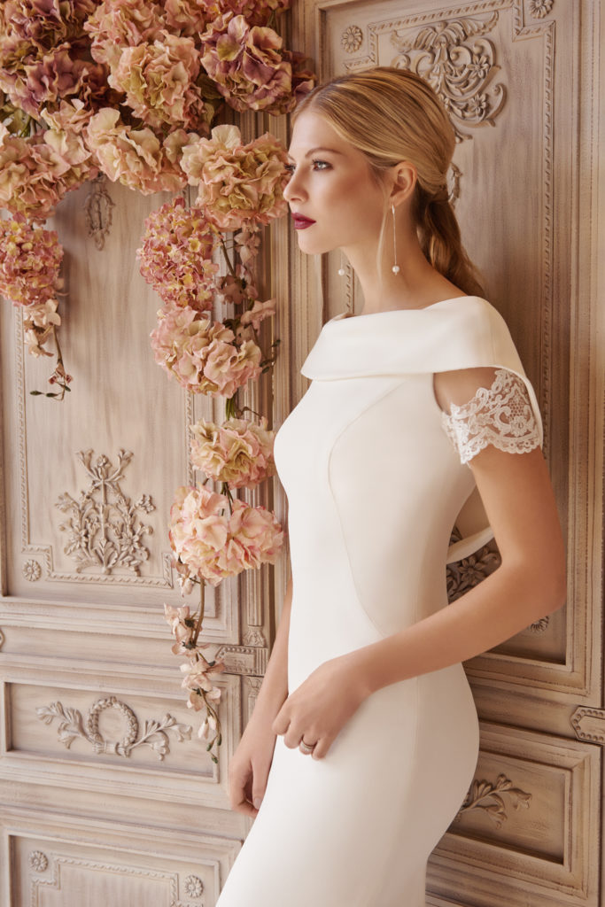 Our unique dress Rieko is designed and made using a crepe silk, through our made to measure service. Pairing it with a delicate lace around the sleeve and train, in a fitted style we have been able to create a modern take on a classic shape. Finally, having a soft open scoop neck and low back we are allowing the light to capture the essence of the wearer and highlight her best features.
