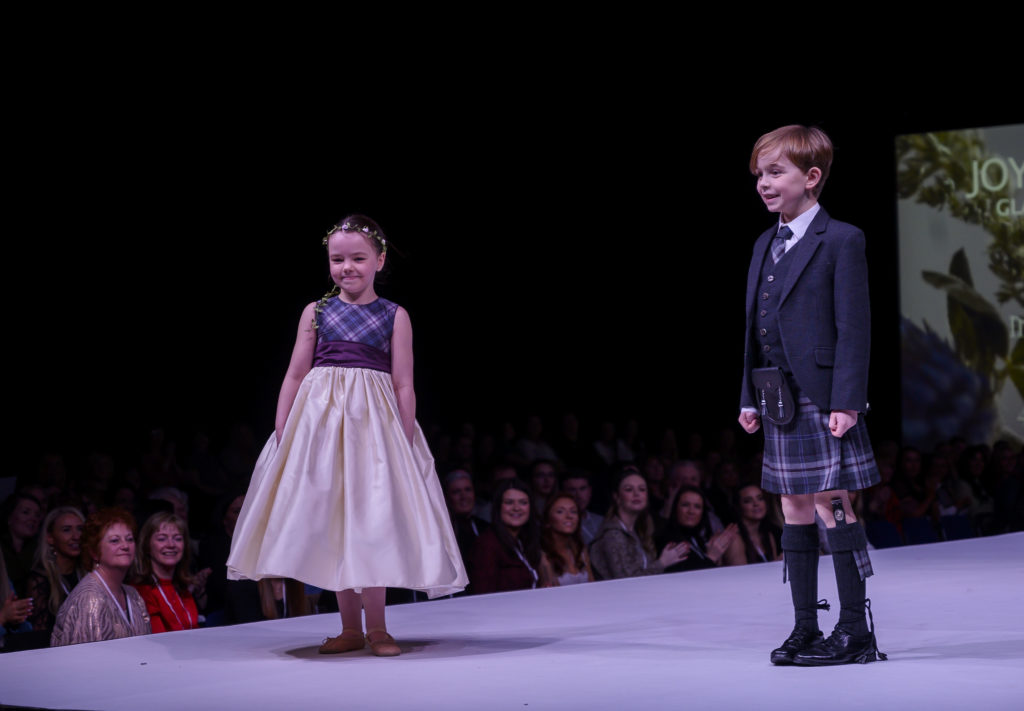 Scottish wedding show flower girl dress in the MacGregor and macduff islay mist tartan SWS 2020 Feb. Joyce Young and MacGregor MacDuff photographs by Alan Peebles