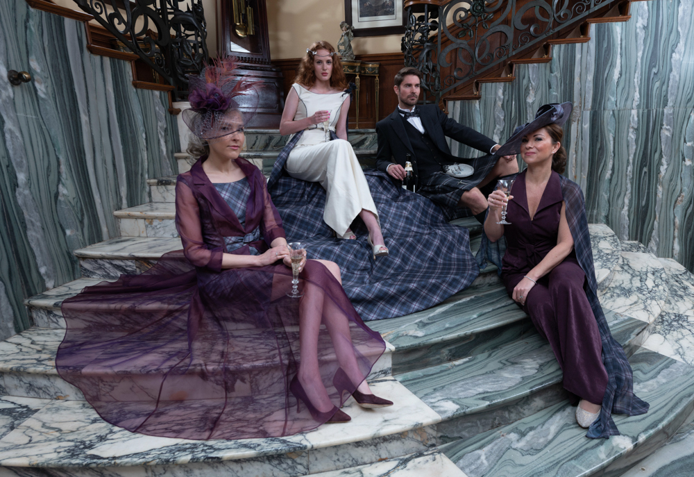 Bride and groom and attendants sitting on marble staircase