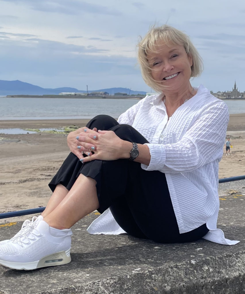 Joyce sitting on the sea wall in Saltcoats