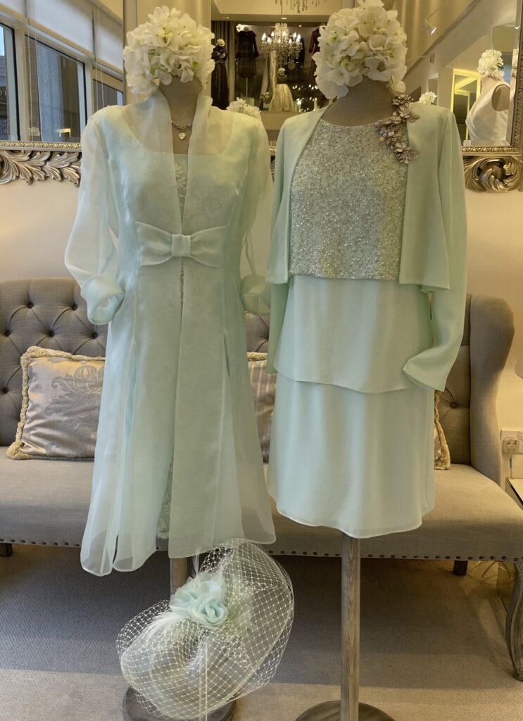 2 dress dummies wearing silk outfits for a wedding