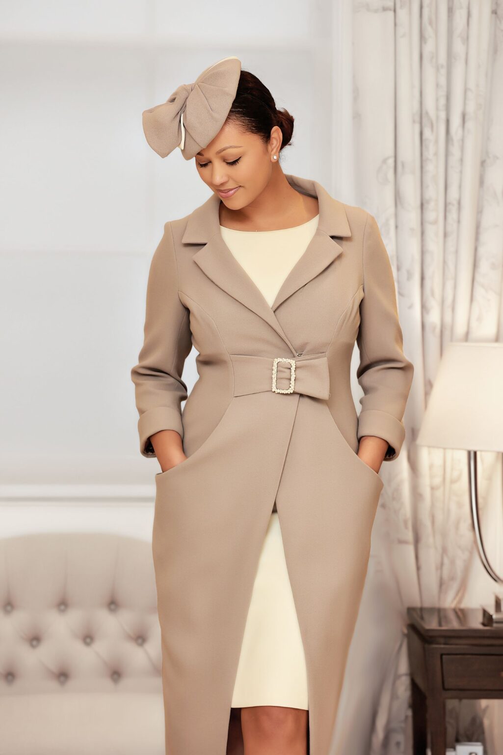 tulip shaped wool coat with pearl buckle over ivory straight wool dress