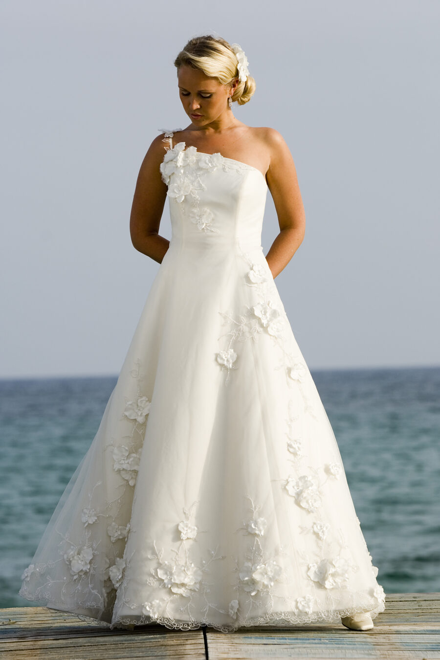 Model wearing wedding dress on jetty