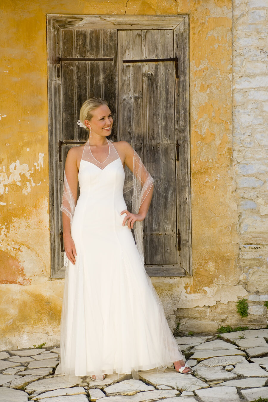 model wearing wedding dress in front of shabby chic door