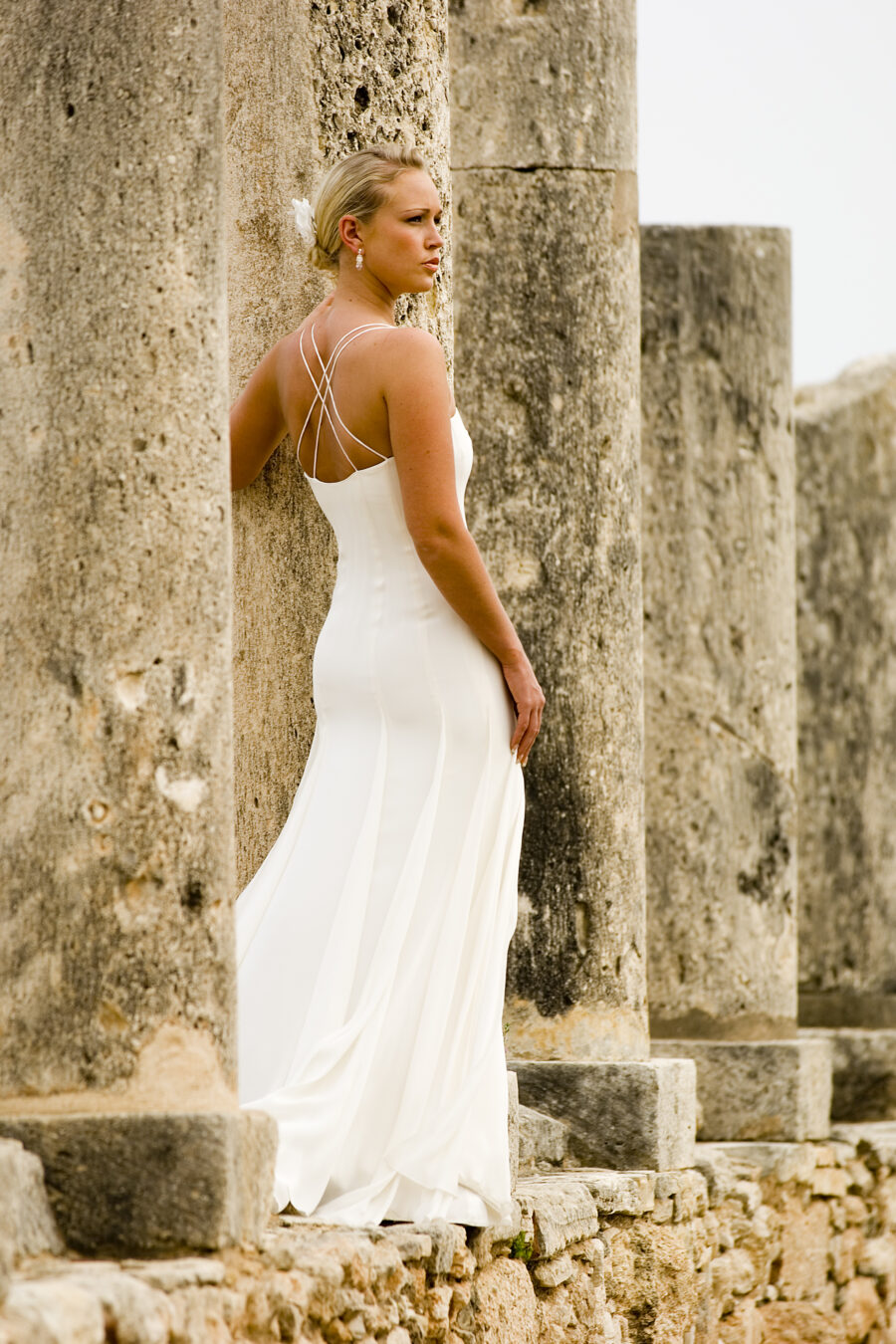 model posing in Greek ruins in wedding dress
