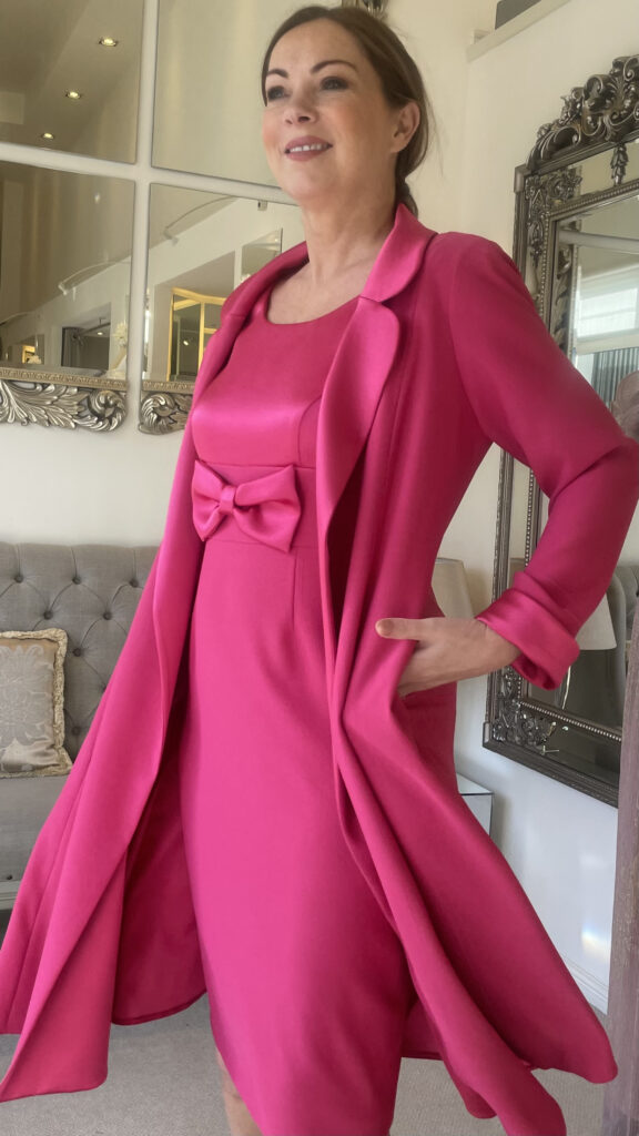 model in cerise dress and coat